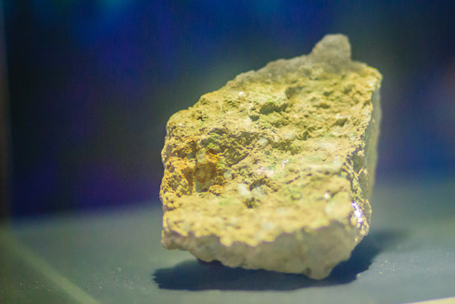 A specimen of yellowcake uranium ore on display
